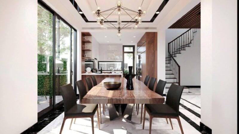 Bàn gỗ óc chó nguyên khối tạo điểm nhấn ấn tượng trong thiết kế nội thất phòng ăn.