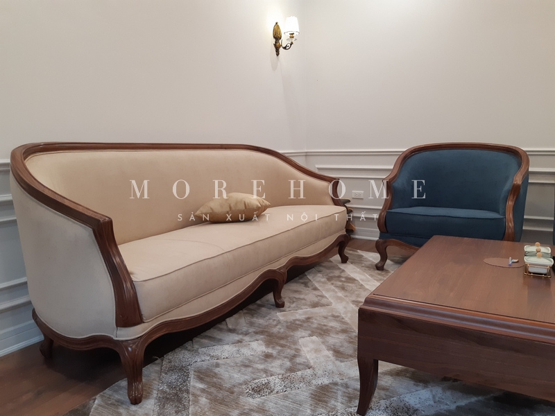 Sofa văng dài có khung gỗ óc chó bọc nỉ màu be tân cổ điển, nhưng các chi tiết đường cong mềm mại tinh tế làm nổi bật sự sang trọng, cao cấp của không gian.